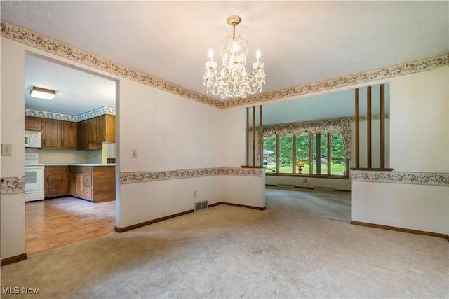 5200 Tanglewood Ave NE, Louisville, OH 44641 - unfurnished room with a chandelier and light colored carpet