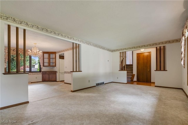 5200 Tanglewood Ave NE, Louisville, OH 44641 - empty room featuring a chandelier, stairway, and carpet flooring