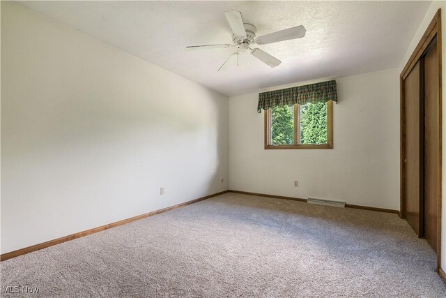 5200 Tanglewood Ave NE, Louisville, OH 44641 - unfurnished bedroom with carpet flooring, a closet, and ceiling fan