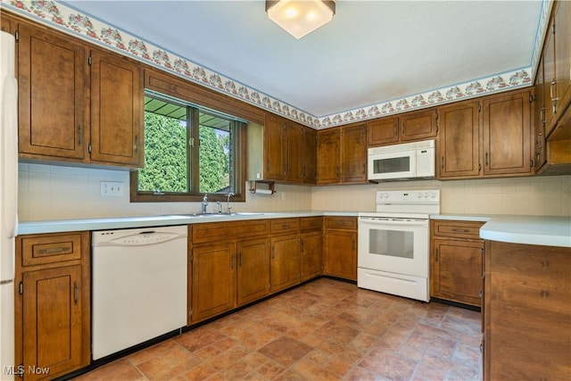 5200 Tanglewood Ave NE, Louisville, OH 44641 - kitchen featuring white appliances, light countertops, stone finish floors, and decorative backsplash