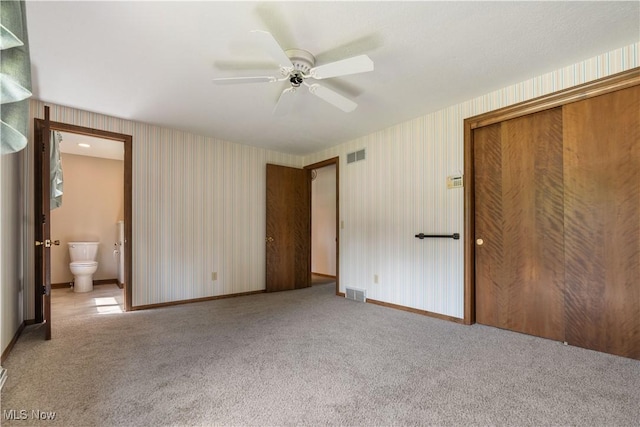 5200 Tanglewood Ave NE, Louisville, OH 44641 - unfurnished bedroom featuring wallpapered walls, carpet flooring, a closet, connected bathroom, and ceiling fan