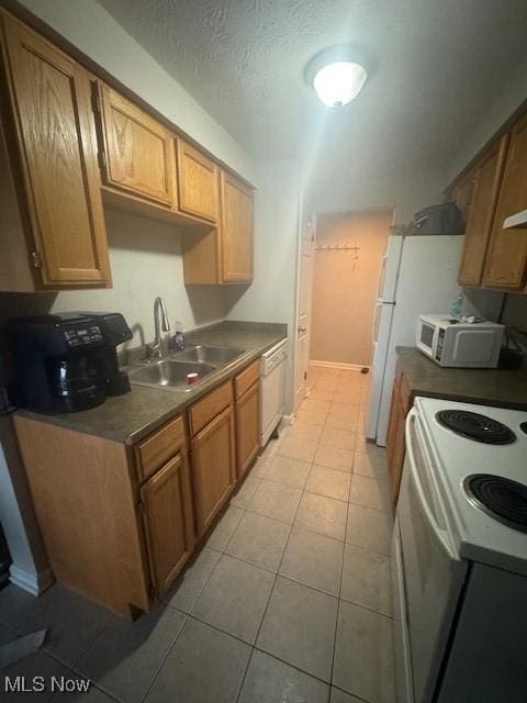 4383 Inner Circle Dr Unit B22, Brunswick, OH 44212 - kitchen with white appliances, light tile patterned flooring, and dark countertops