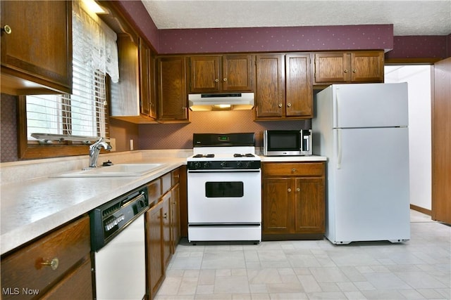 894 Pearson Cir Unit 3, Boardman, OH 44512 - kitchen with white appliances, under cabinet range hood, light countertops, and a textured ceiling