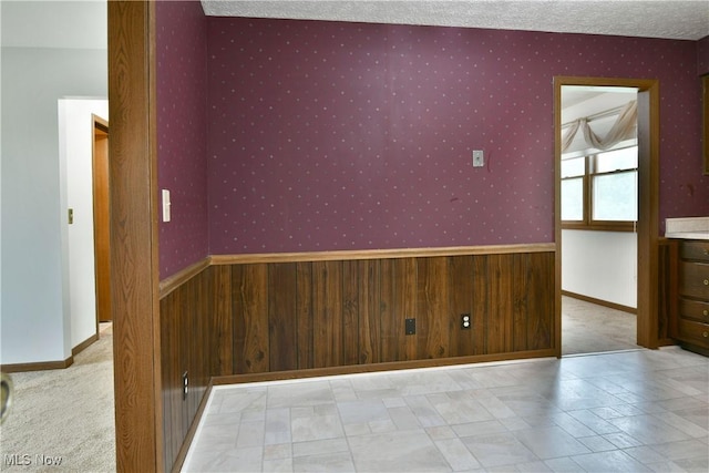 894 Pearson Cir Unit 3, Boardman, OH 44512 - spare room featuring wallpapered walls and a textured ceiling