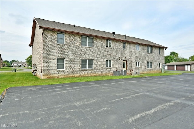 894 Pearson Cir Unit 3, Boardman, OH 44512 - back of property with brick siding, a yard, and a garage