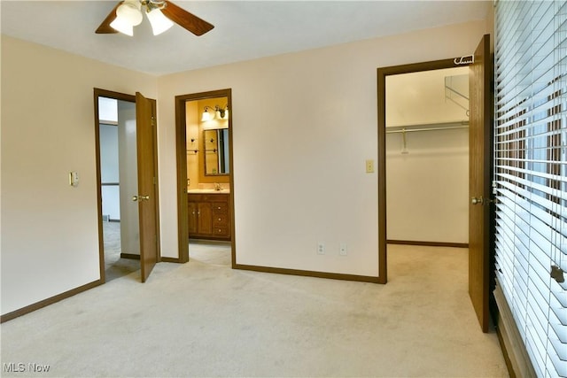 894 Pearson Cir Unit 3, Boardman, OH 44512 - unfurnished bedroom with light carpet, a walk in closet, ensuite bath, and a ceiling fan