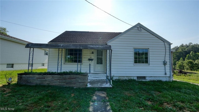 60 S Liberty St, New Concord, OH 43762 - bungalow-style home with a front yard, roof with shingles, and a porch