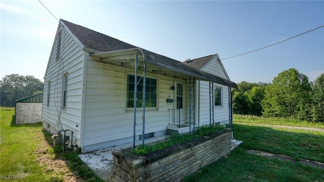 60 S Liberty St, New Concord, OH 43762 - view of home's exterior with roof with shingles and a lawn
