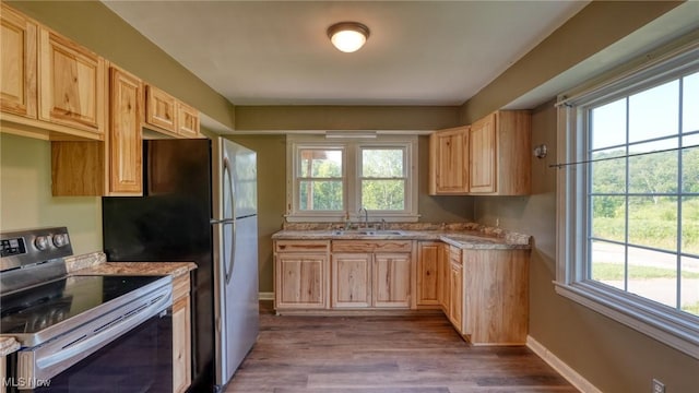 60 S Liberty St, New Concord, OH 43762 - kitchen with stainless steel range with electric cooktop, light brown cabinetry, dark wood-style floors, and light countertops