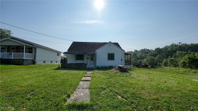 60 S Liberty St, New Concord, OH 43762 - view of front facade featuring covered porch and a front lawn