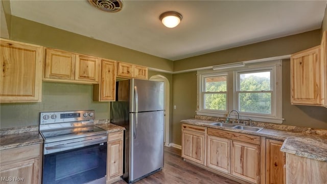60 S Liberty St, New Concord, OH 43762 - kitchen with appliances with stainless steel finishes, light brown cabinets, and dark wood-style flooring