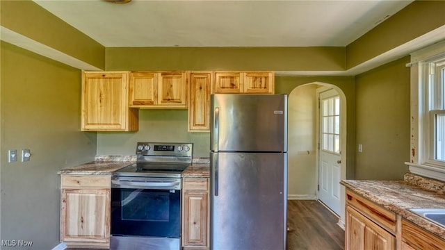 60 S Liberty St, New Concord, OH 43762 - kitchen featuring appliances with stainless steel finishes, arched walkways, dark wood-type flooring, and light brown cabinets