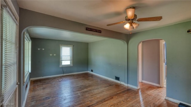 60 S Liberty St, New Concord, OH 43762 - empty room with arched walkways, wood finished floors, and ceiling fan
