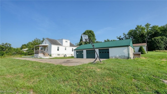 60 S Liberty St, New Concord, OH 43762 - back of property with an outbuilding, a yard, a metal roof, and a garage