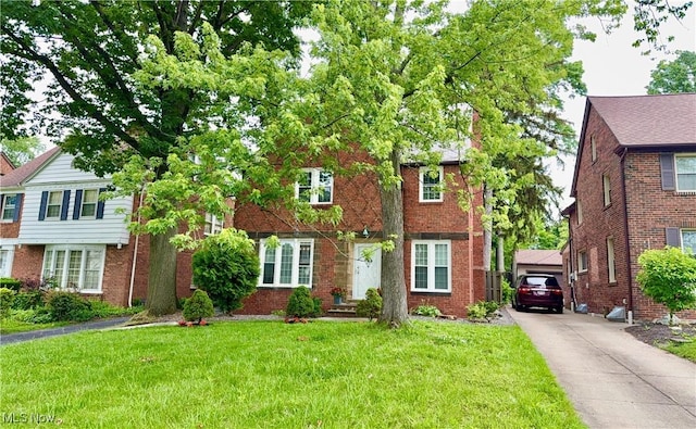 16721 Lomond Blvd, Shaker Heights, OH 44120 - view of front of property with a front yard, driveway, and brick siding