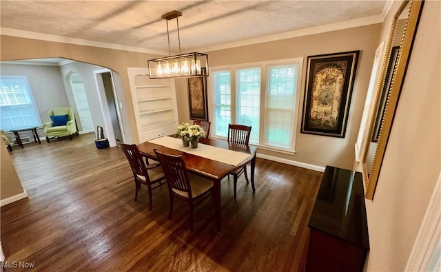 16721 Lomond Blvd, Shaker Heights, OH 44120 - dining space with dark wood-style flooring, arched walkways, a textured ceiling, ornamental molding, and a chandelier