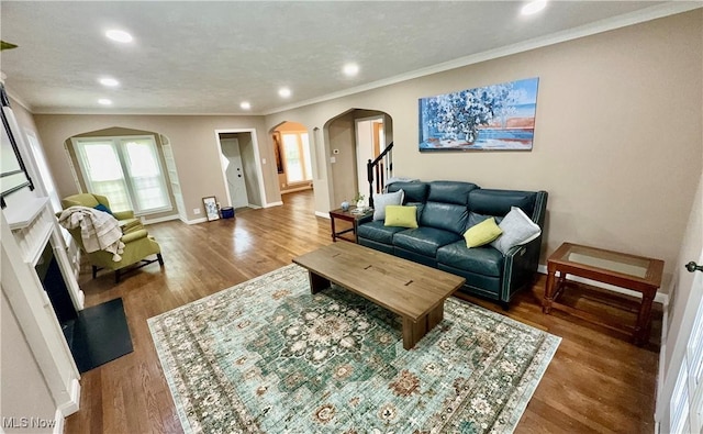 16721 Lomond Blvd, Shaker Heights, OH 44120 - living room with arched walkways, recessed lighting, crown molding, wood finished floors, and stairway