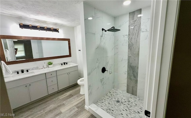 16721 Lomond Blvd, Shaker Heights, OH 44120 - full bath featuring double vanity, wood finished floors, a marble finish shower, and a textured ceiling