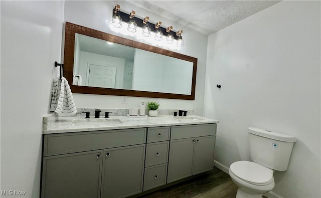 16721 Lomond Blvd, Shaker Heights, OH 44120 - bathroom featuring double vanity, wood finished floors, and a textured ceiling