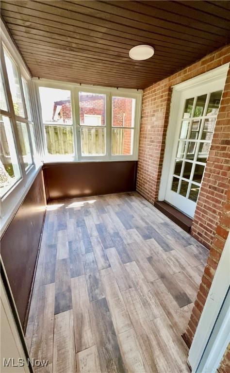 16721 Lomond Blvd, Shaker Heights, OH 44120 - unfurnished sunroom featuring brick wall, wooden ceiling, and wood finished floors