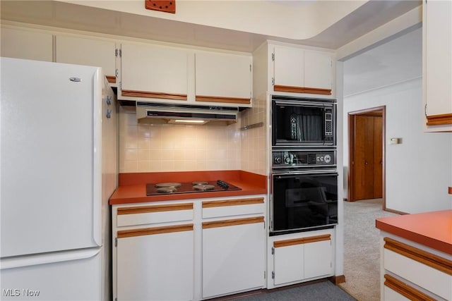 7080 Arcadia Dr, Parma, OH 44129 - kitchen featuring black appliances, decorative backsplash, under cabinet range hood, white cabinets, and carpet floors