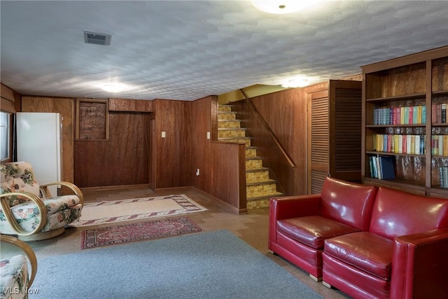 7080 Arcadia Dr, Parma, OH 44129 - living area with stairway, wood walls, and carpet flooring