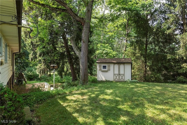 7080 Arcadia Dr, Parma, OH 44129 - view of grassy yard featuring a storage shed and a wall mounted AC