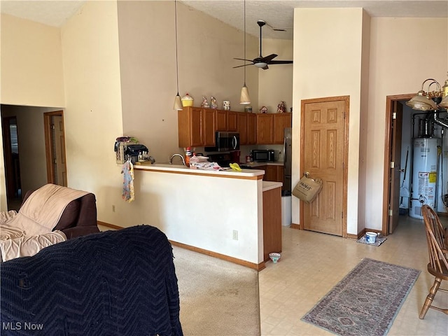 16199 Emerald Pt, Middleburg Heights, OH 44130 - kitchen featuring high vaulted ceiling, stainless steel microwave, gas water heater, black microwave, and freestanding refrigerator