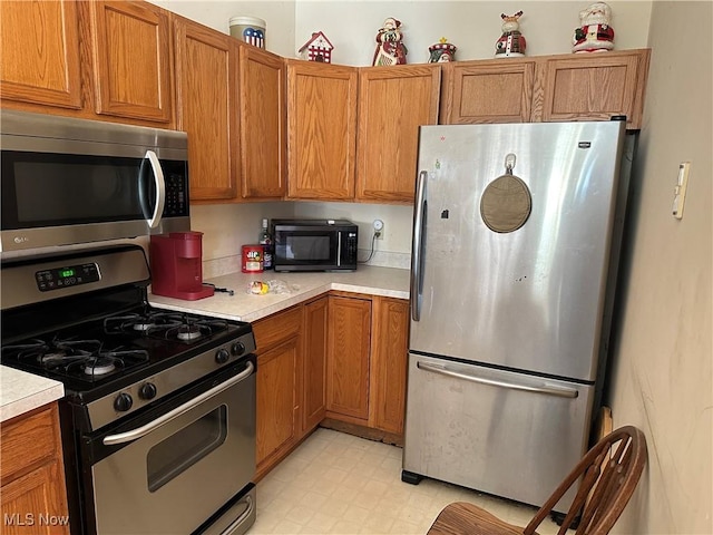 16199 Emerald Pt, Middleburg Heights, OH 44130 - kitchen with appliances with stainless steel finishes, light countertops, and brown cabinets