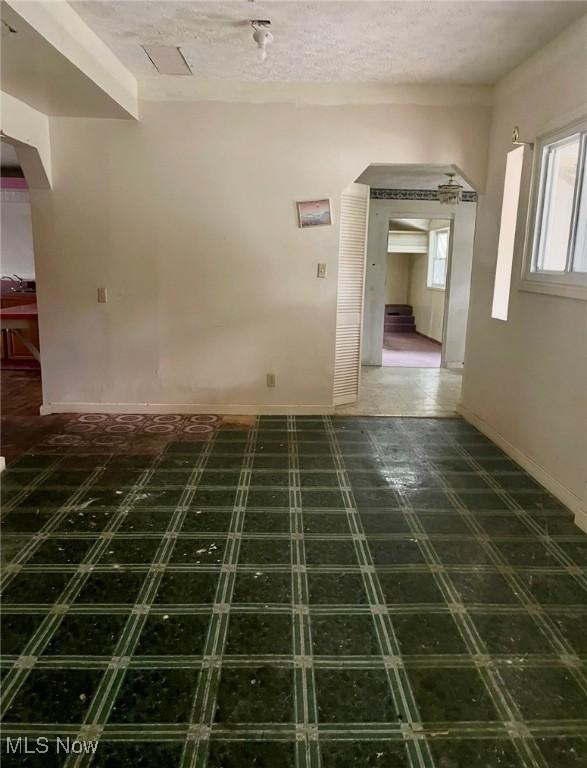 1709 E 29th St, Lorain, OH 44055 - spare room with arched walkways and baseboards