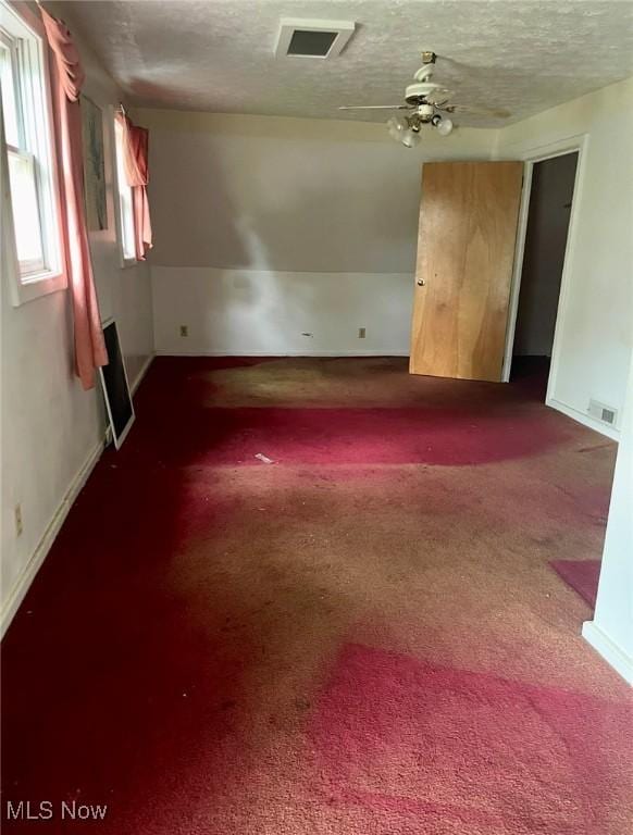 1709 E 29th St, Lorain, OH 44055 - carpeted empty room with a textured ceiling and ceiling fan