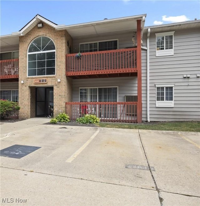 27087 Oakwood Cir Unit 102Y, Olmsted Twp, OH 44138 - view of building exterior with uncovered parking