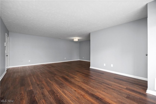 27087 Oakwood Cir Unit 102Y, Olmsted Twp, OH 44138 - empty room with dark wood-type flooring and a textured ceiling