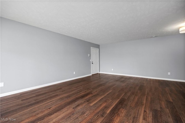 27087 Oakwood Cir Unit 102Y, Olmsted Twp, OH 44138 - empty room with dark wood finished floors and a textured ceiling