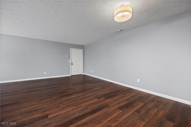 27087 Oakwood Cir Unit 102Y, Olmsted Twp, OH 44138 - unfurnished room with dark wood finished floors and a textured ceiling