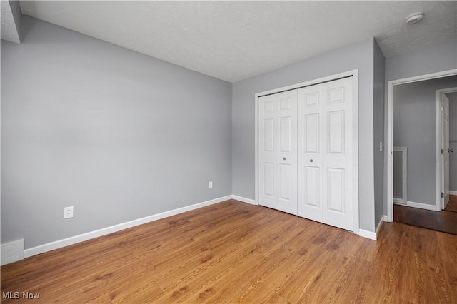 27087 Oakwood Cir Unit 102Y, Olmsted Twp, OH 44138 - unfurnished bedroom featuring light wood-style flooring and a closet