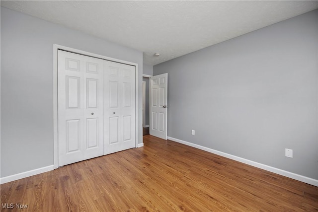 27087 Oakwood Cir Unit 102Y, Olmsted Twp, OH 44138 - unfurnished bedroom featuring wood finished floors and a closet