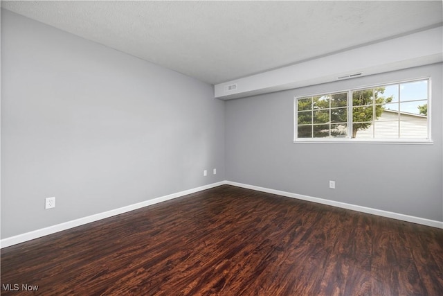 27087 Oakwood Cir Unit 102Y, Olmsted Twp, OH 44138 - empty room featuring baseboards and dark wood-type flooring