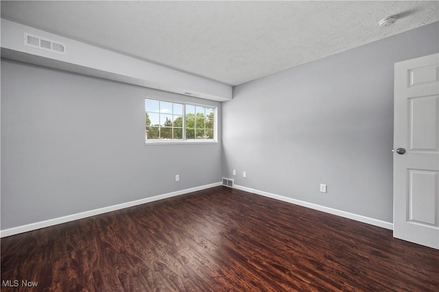 27087 Oakwood Cir Unit 102Y, Olmsted Twp, OH 44138 - empty room with wood finished floors, a smoke detector, and a textured ceiling