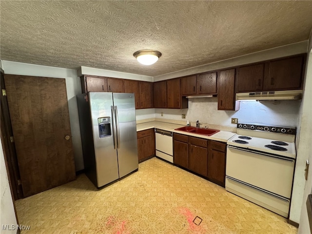 5436 Summerwood Ct Unit C, Willoughby, OH 44094 - kitchen featuring white appliances, under cabinet range hood, light countertops, light floors, and dark brown cabinets