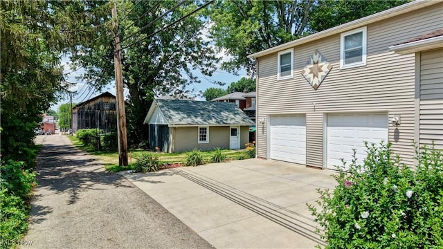 99 Mccook Ave, Carrollton, OH 44615 - view of front of property featuring concrete driveway and an attached garage