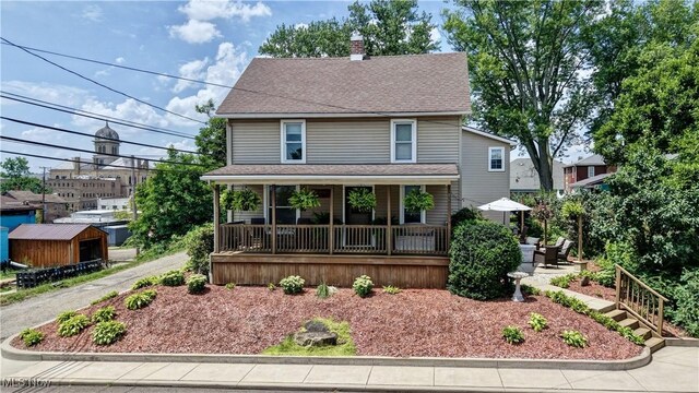 99 Mccook Ave, Carrollton, OH 44615 - traditional style home with covered porch, a chimney, and roof with shingles