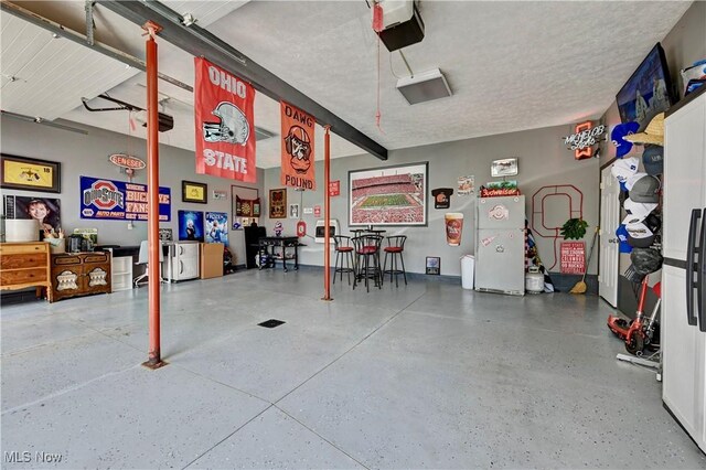 99 Mccook Ave, Carrollton, OH 44615 - garage featuring freestanding refrigerator and a garage door opener