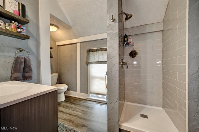 99 Mccook Ave, Carrollton, OH 44615 - full bathroom featuring a textured ceiling, wood finished floors, vaulted ceiling, a shower stall, and vanity