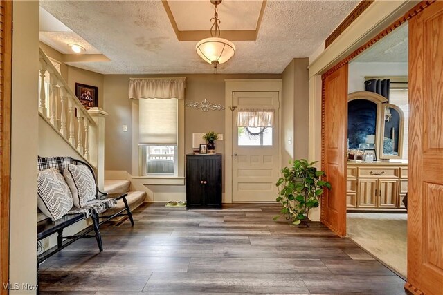 99 Mccook Ave, Carrollton, OH 44615 - foyer entrance with a textured ceiling, stairway, and wood finished floors