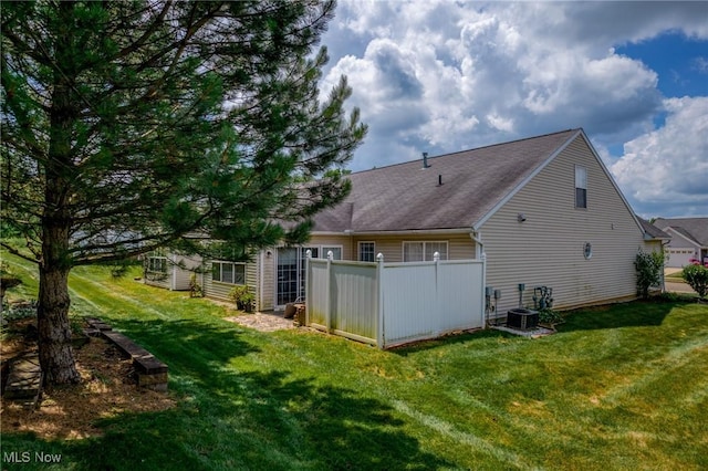 1446 Chesapeake Ave, Louisville, OH 44641 - rear view of house featuring a yard and a shingled roof