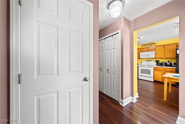 1446 Chesapeake Ave, Louisville, OH 44641 - hall featuring dark wood-style flooring and baseboards