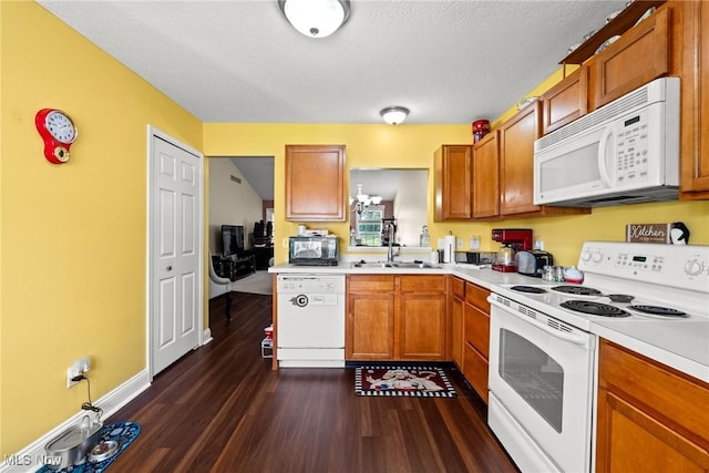 1446 Chesapeake Ave, Louisville, OH 44641 - kitchen with white appliances, light countertops, dark wood finished floors, and brown cabinets