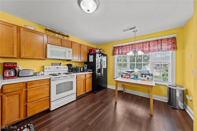1446 Chesapeake Ave, Louisville, OH 44641 - kitchen with white appliances, dark wood finished floors, light countertops, and brown cabinets