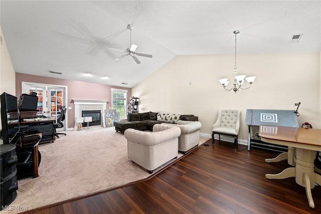 1446 Chesapeake Ave, Louisville, OH 44641 - living area featuring a chandelier, a ceiling fan, wood finished floors, vaulted ceiling, and a glass covered fireplace